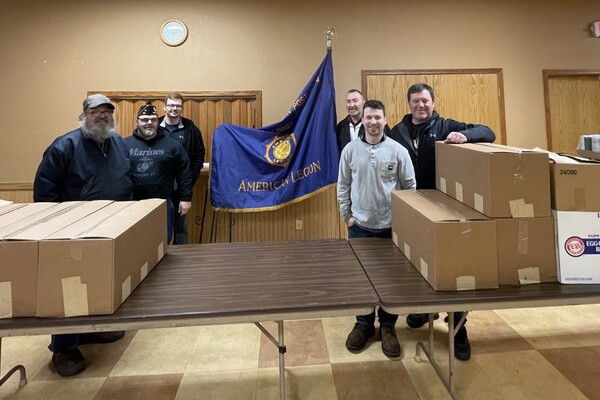 Clow Valve presents American Legion Post 34 with food donation and care package